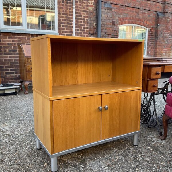 Oak effect media cabinet with cupboard and open shelf.