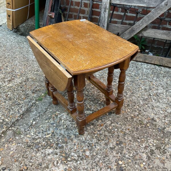 Vintage oak folding gate leg table with leaves down.