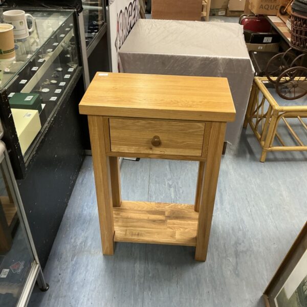 Vintage oak side table with drawer, ideal for bedrooms or hallways.