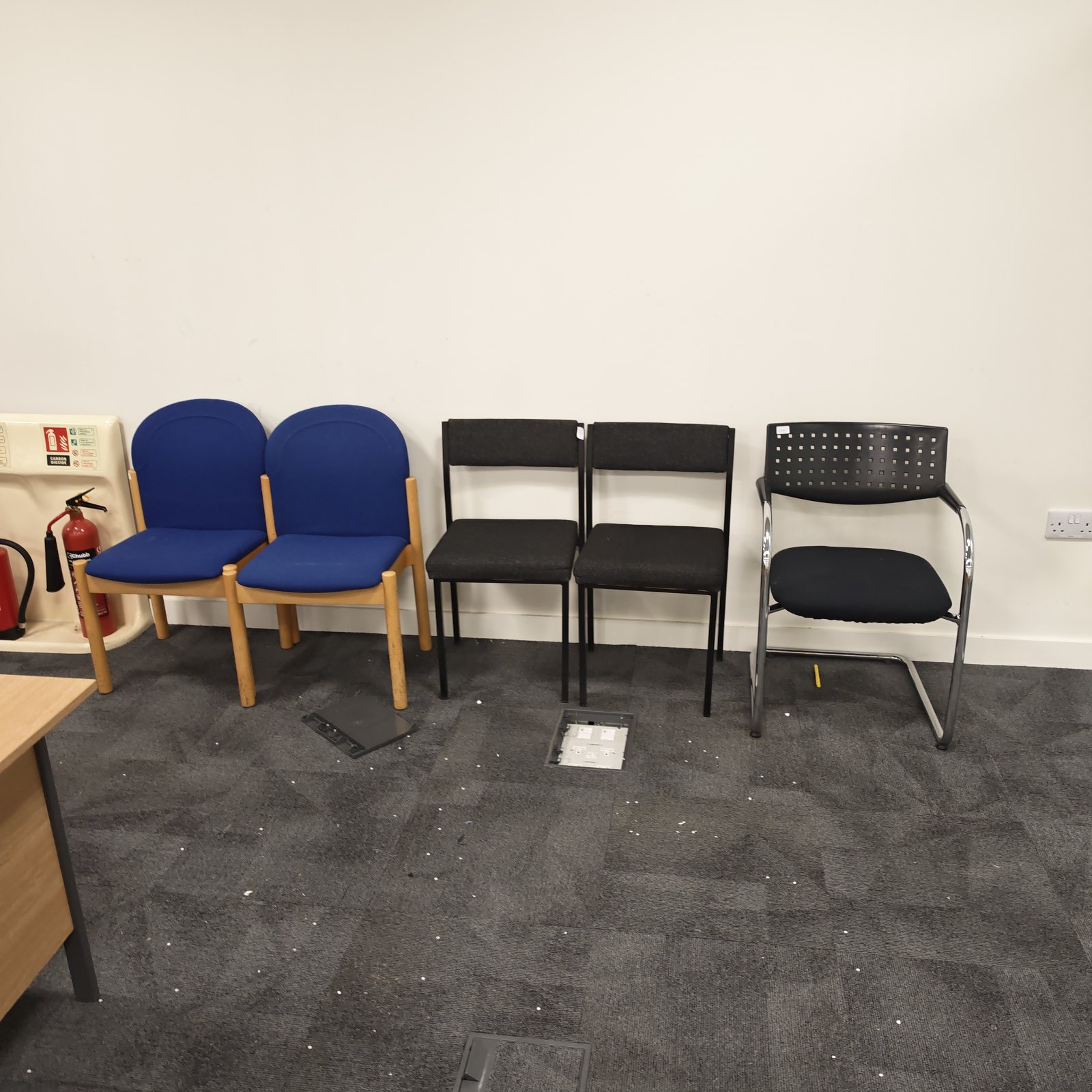 Bundle of used office reception chairs in blue and black.