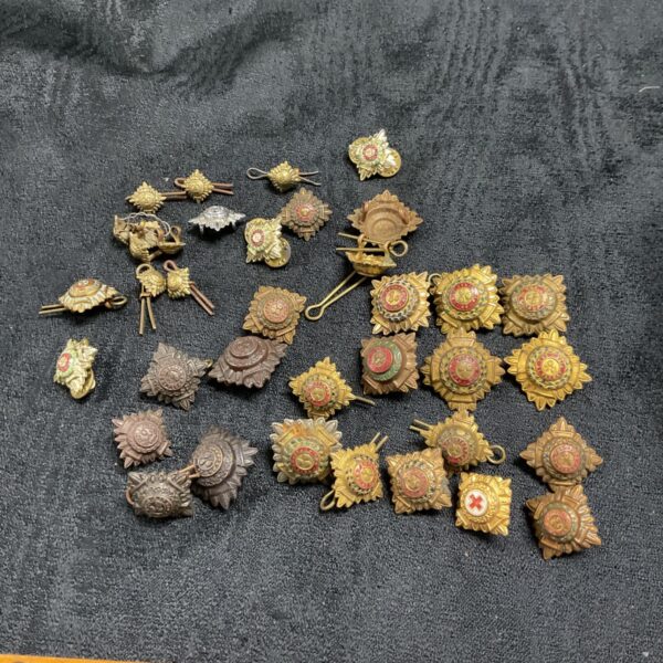 Vintage officers rank pips collection, brass military insignia.