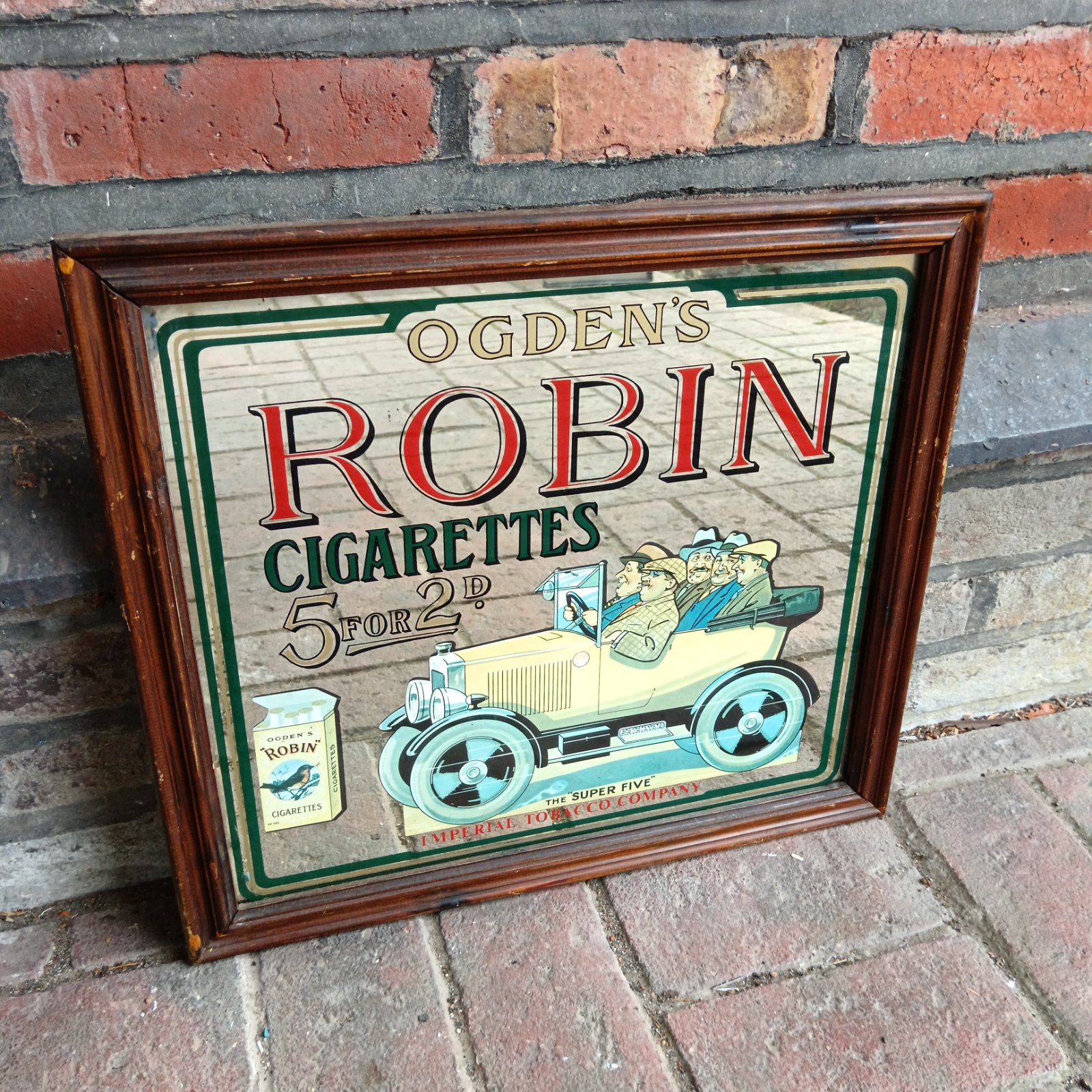 Vintage Ogden's Robin cigarettes advertising mirror with classic car.