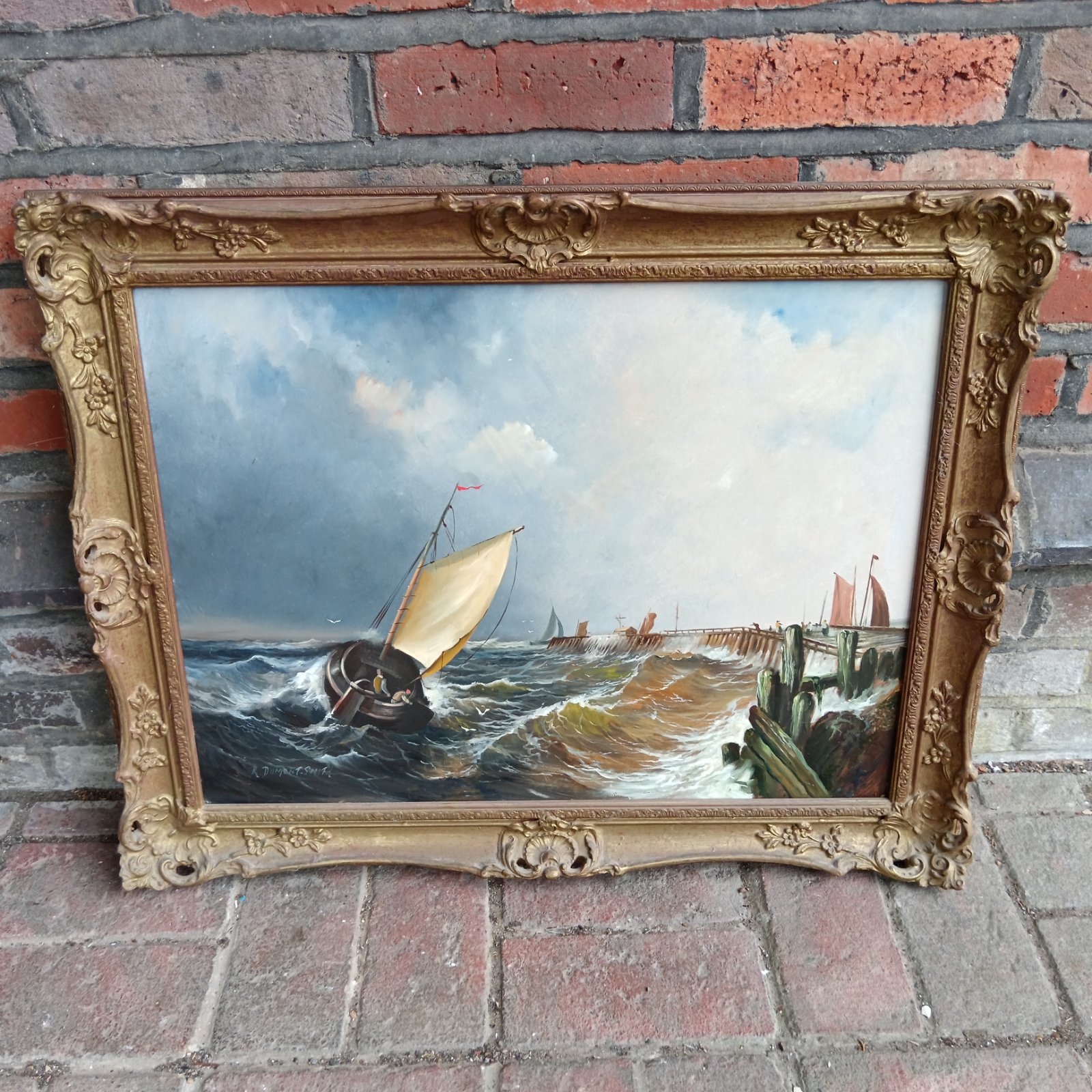 Vintage oil painting of a sailboat in rough seas with ornate frame.