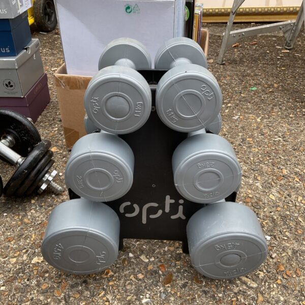 Stack of grey Opti fitness weights for home gym use.