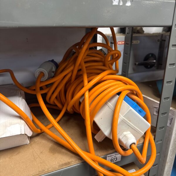 Bright orange four-gang camp site hook up lead for caravan power.