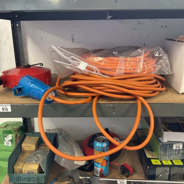 Orange mains electric hook-up extension cable for caravan or camping use.