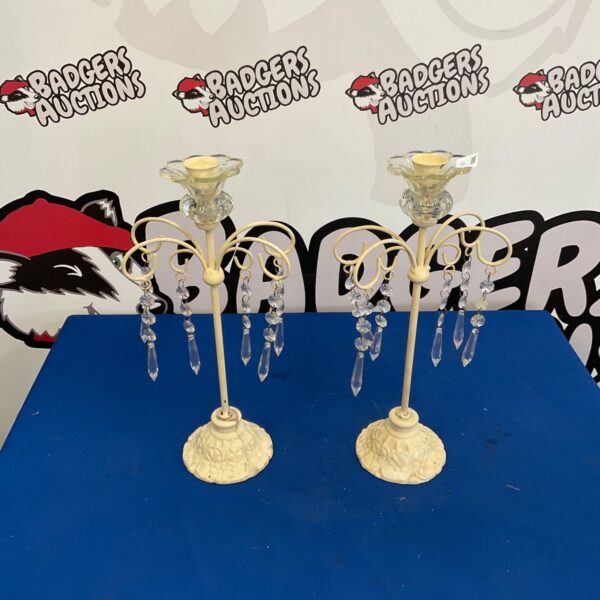 Ornate vintage candle holders with detailed brass construction.
