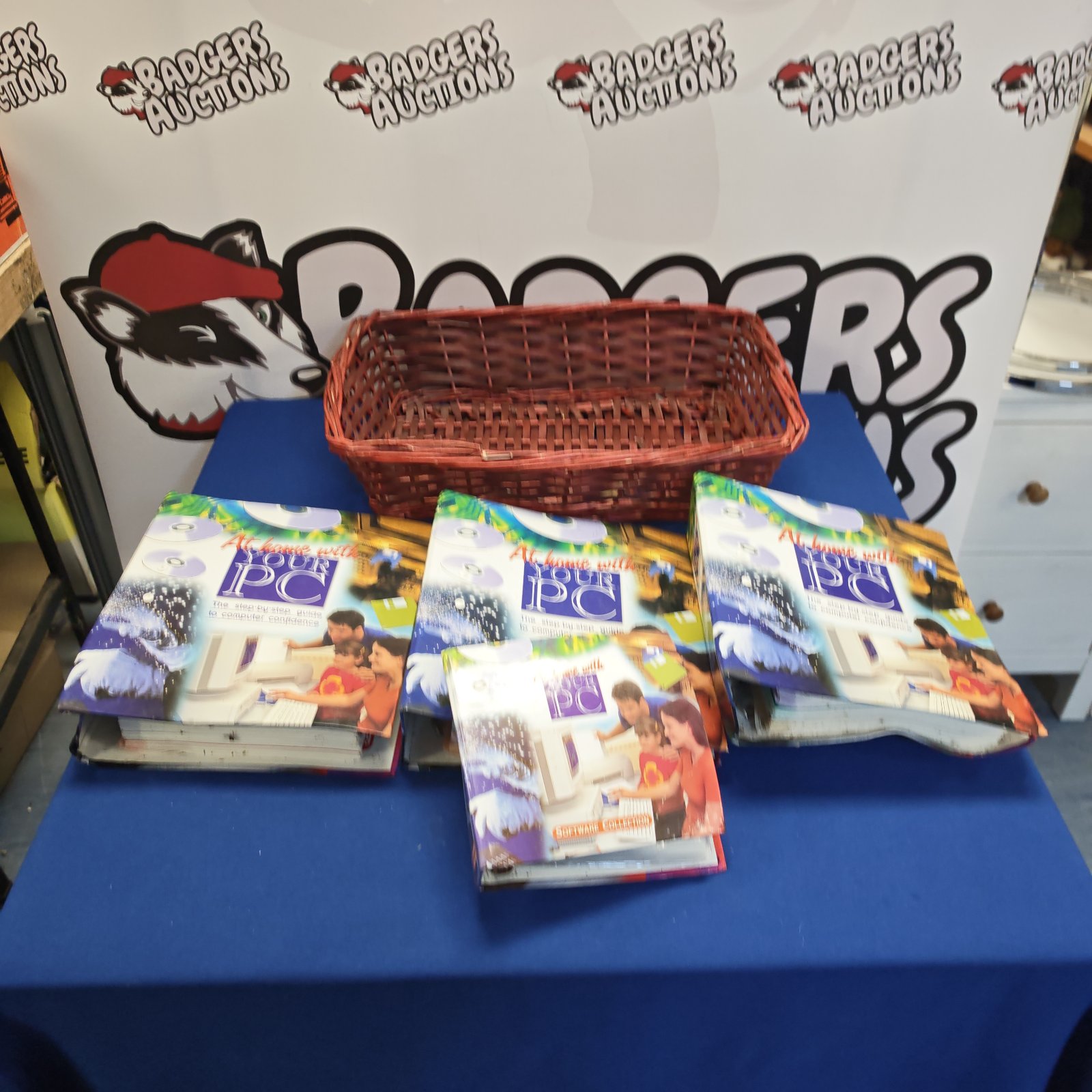 Woven basket containing vintage PC folders and CDs for home learning.