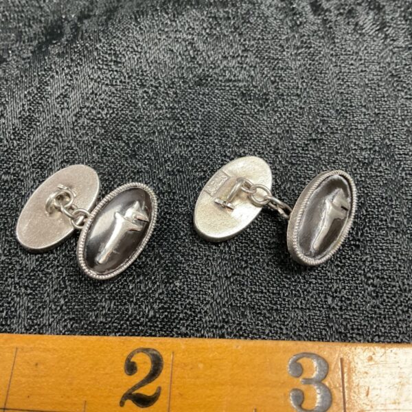 Antique Persian silver cufflinks with animal crests and beaded rims.