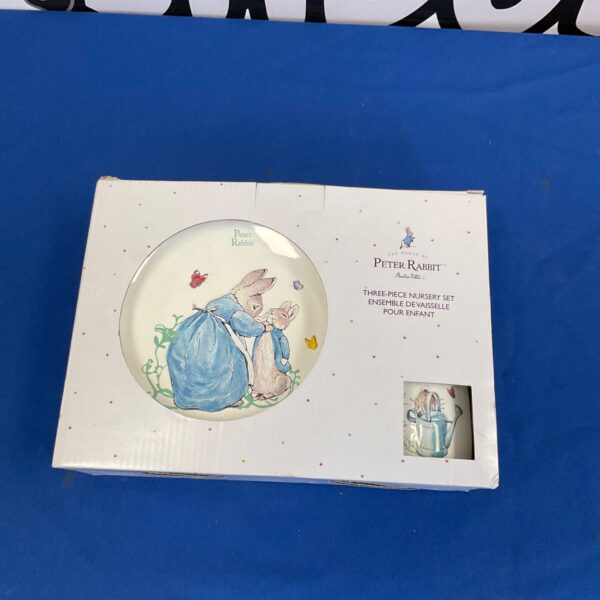 Vintage Peter Rabbit nursery set with plate, bowl, and mug.