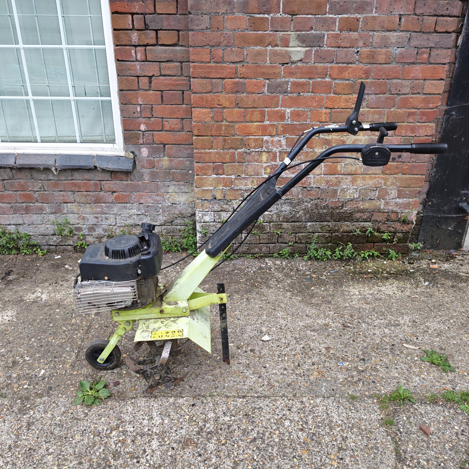 Used petrol rotavator for garden soil cultivation.