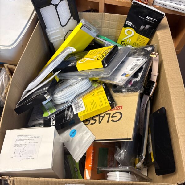 Box of new phone accessories and Nintendo DS screen protectors.