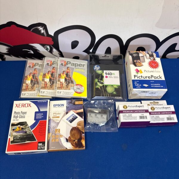 Mixed lot of photo paper and printer ink cartridges for home printing.