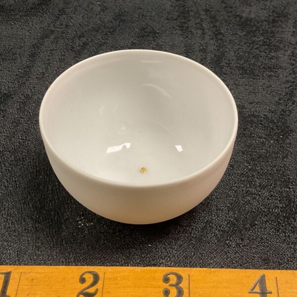 White porcelain Pieter Stockmans saki cup with ruler for scale.