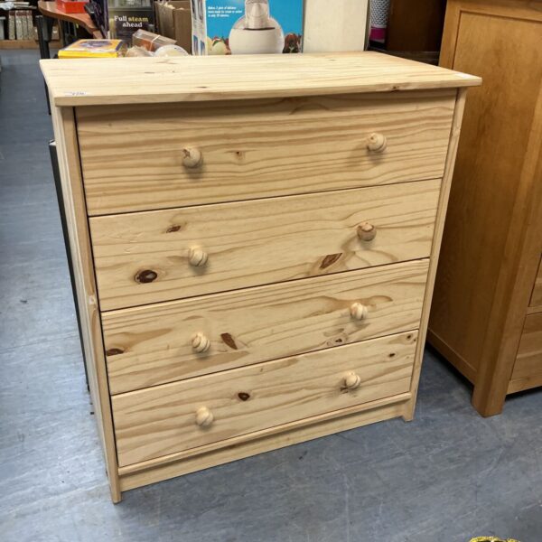 Vintage pine four drawer dresser with a natural wood finish.
