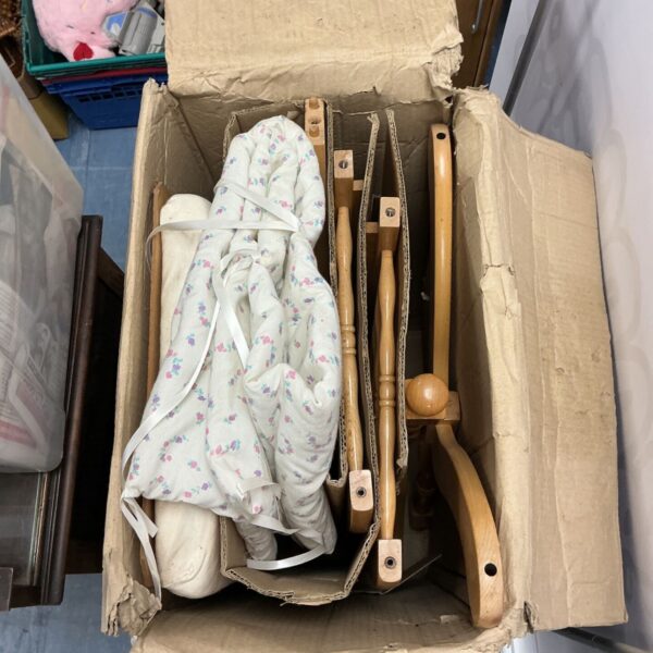 Vintage pine rocking baby crib with fabric panels.