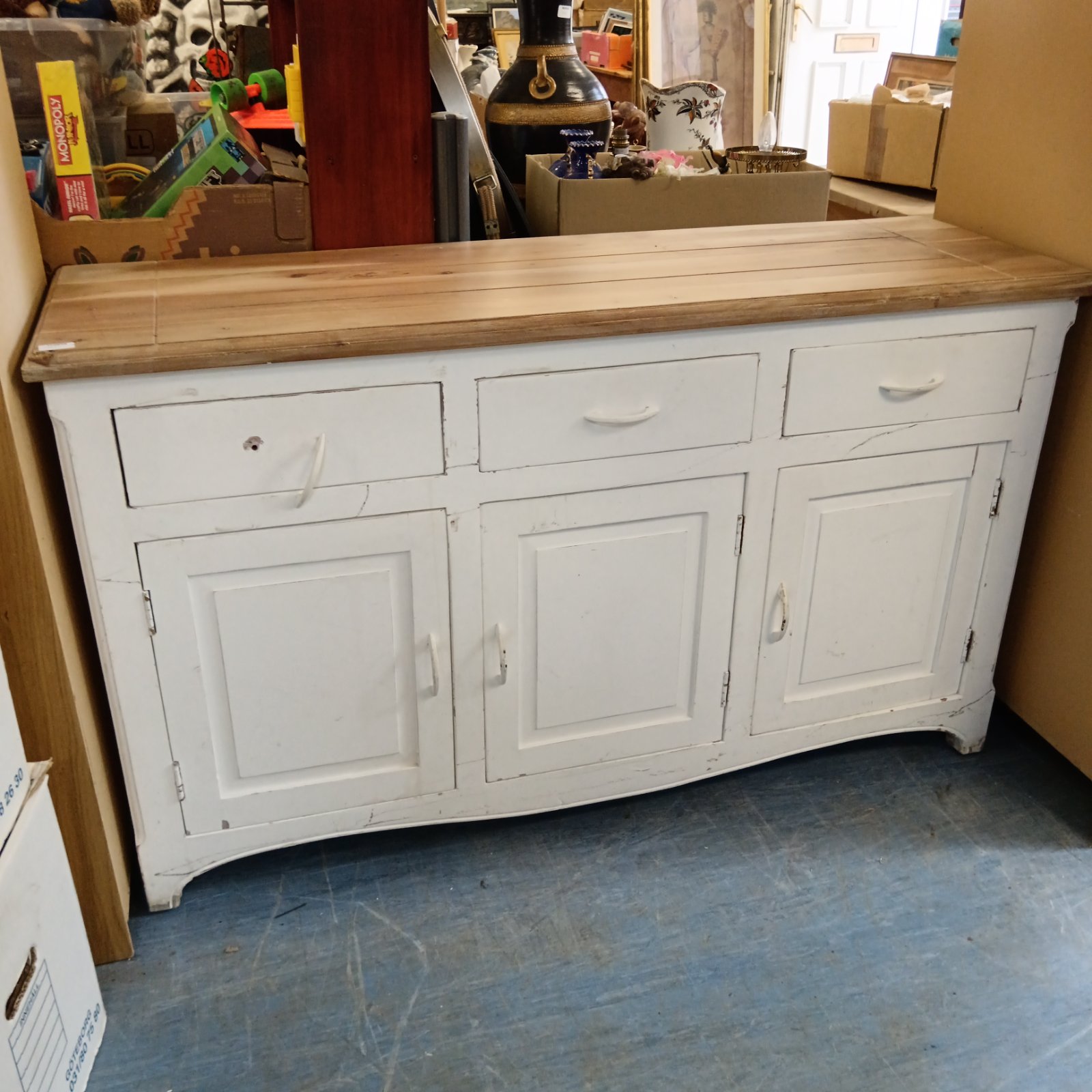 Rustic pine sideboard with three drawers and cupboard doors.