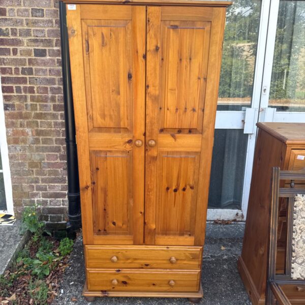 Vintage pine wardrobe with two doors and drawers.