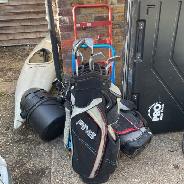 Black Ping golf bag with a set of golf clubs visible.