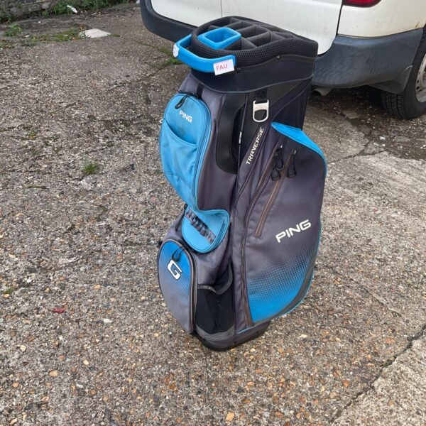Blue Ping Traverse golf bag on a golf course.