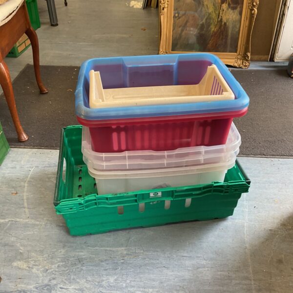 Colourful plastic storage boxes stacked, ideal for household organisation.
