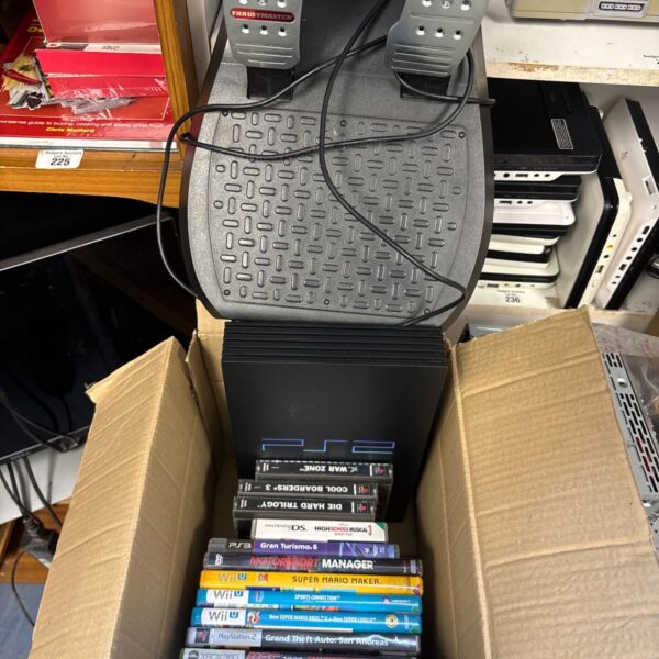 PlayStation 2 console bundle with Thrustmaster pedals and games.