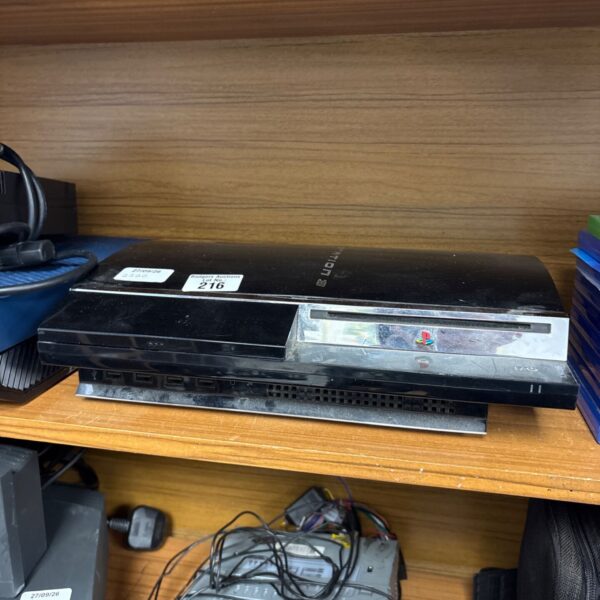 Black Sony PlayStation 3 console with auction stickers.