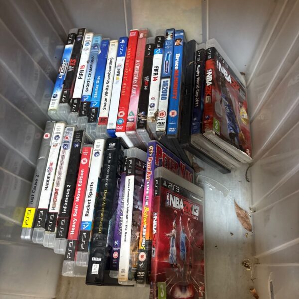 A box of assorted PlayStation games including PS3 and PS4 titles.