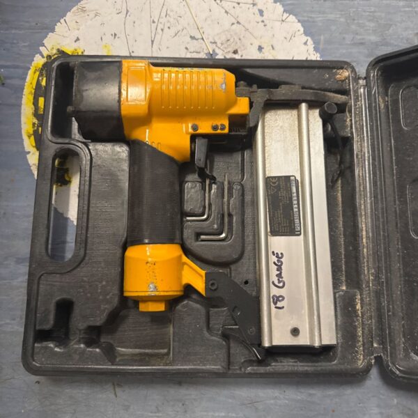 Used 18 gauge pneumatic staple gun inside its carrying case.