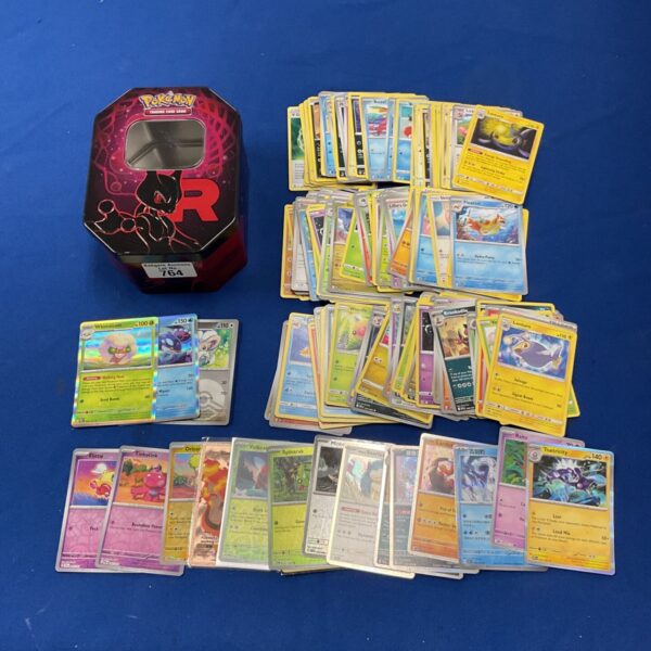 Pokemon card tin with holographic cards inside, collectible trading cards.