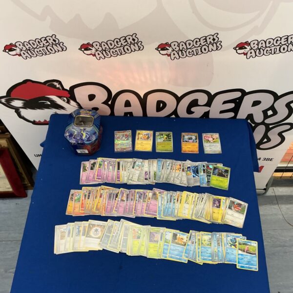 Assorted Pokémon cards inside a Paldea Legends Tin for collectors.