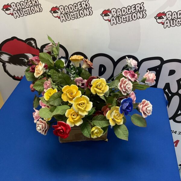 Colourful porcelain rose bouquet in a rustic box.