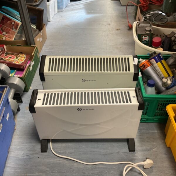White portable convector heater with carry handle.