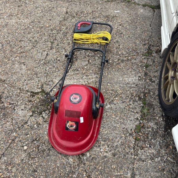 Vintage Power Devil garden hover mower with electrical cord.