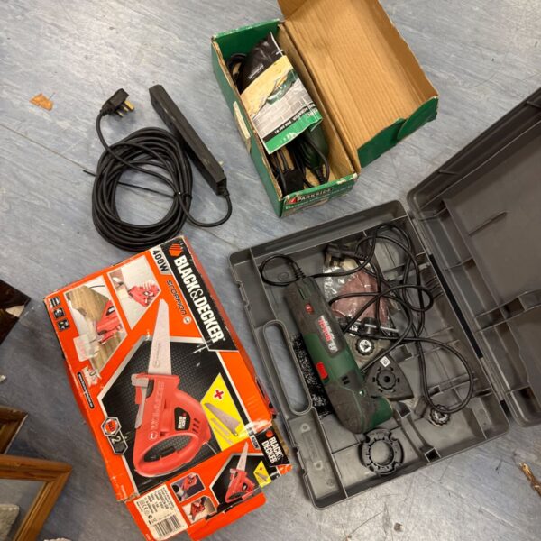 Power tool bundle including Black & Decker Scorpion saw and Bosch sander.