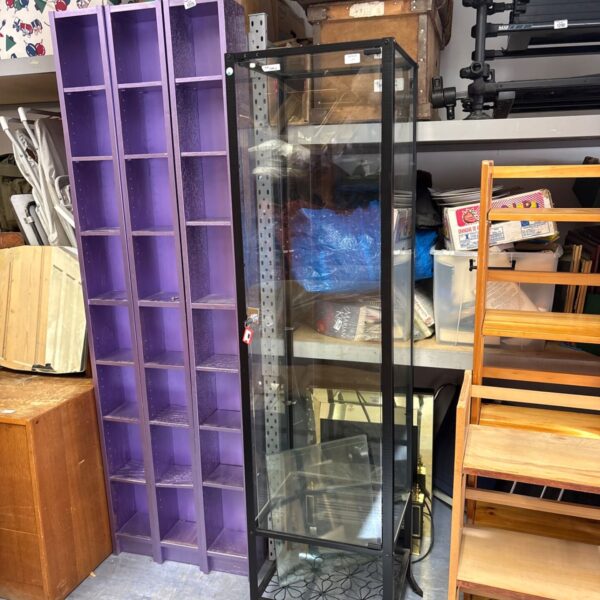 Purple lockable glass display cabinet with glass panes.