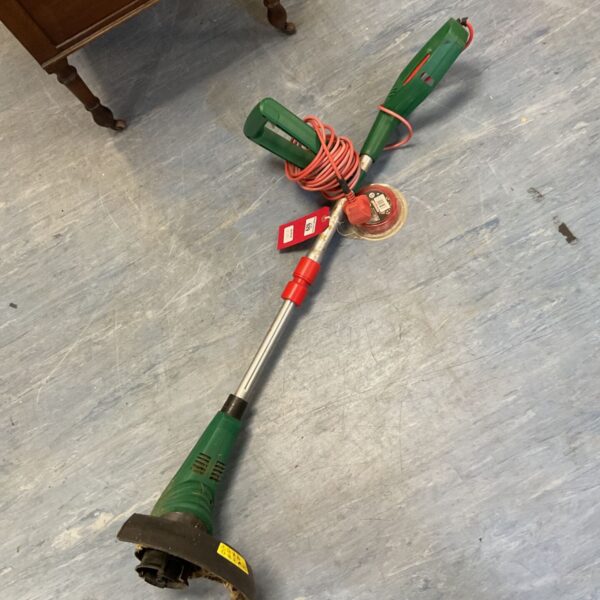 Vintage Qualcast electric strimmer with cord, a classic garden tool.