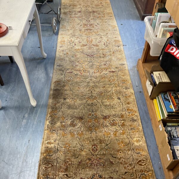 Long Rajput Indian rug runner displayed in a storage area.