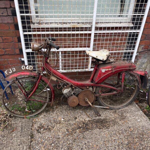 Vintage Raleigh Runabout moped showing registration number.
