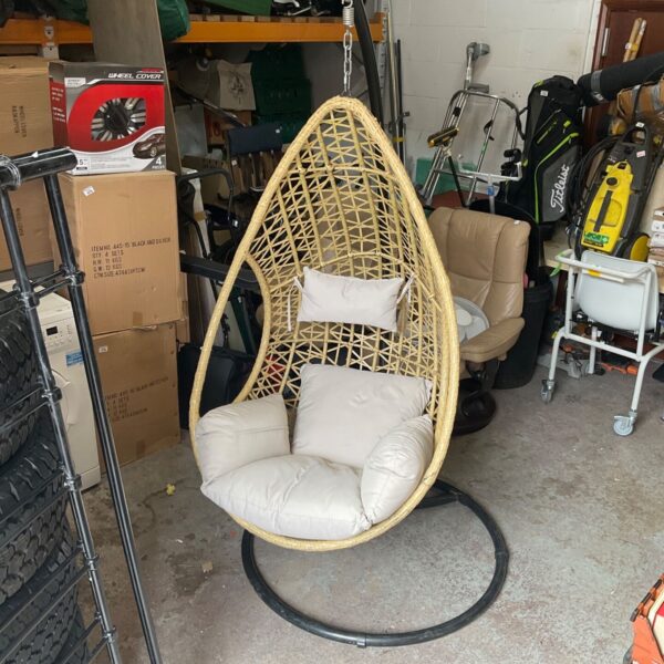 Rattan egg chair with cushions, a stylish boho seating option.