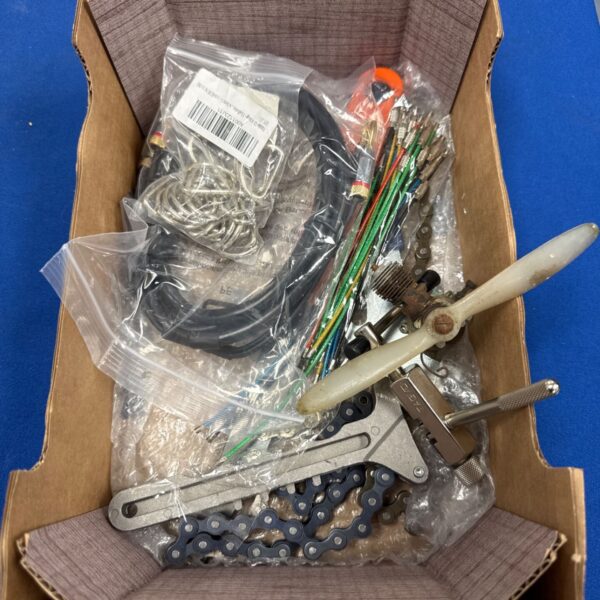 Tray of RC plane engine and assorted hobby parts.