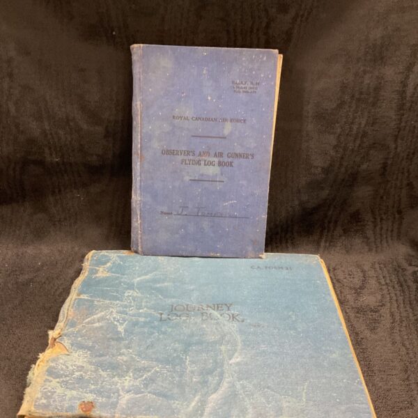 Stack of vintage RCAF flying log books, aviation collectibles.