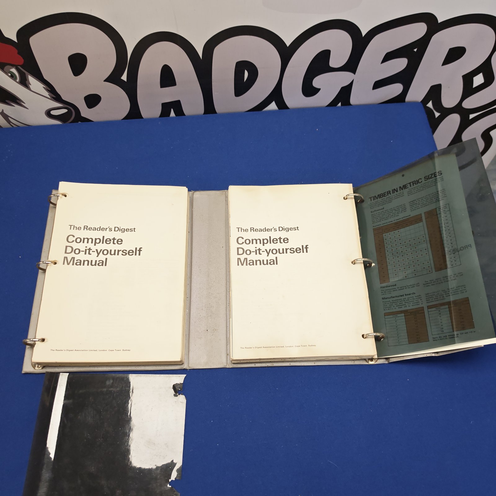 Vintage Reader's Digest DIY manuals displayed against a blue wall.