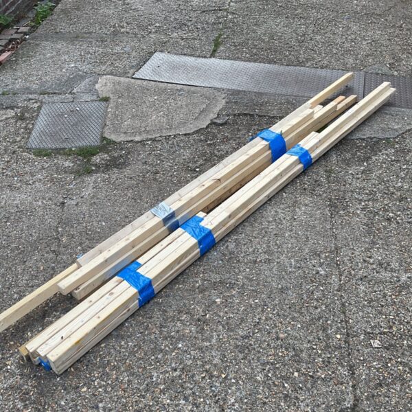 Bundle of reclaimed 2x2 lumber for DIY projects.