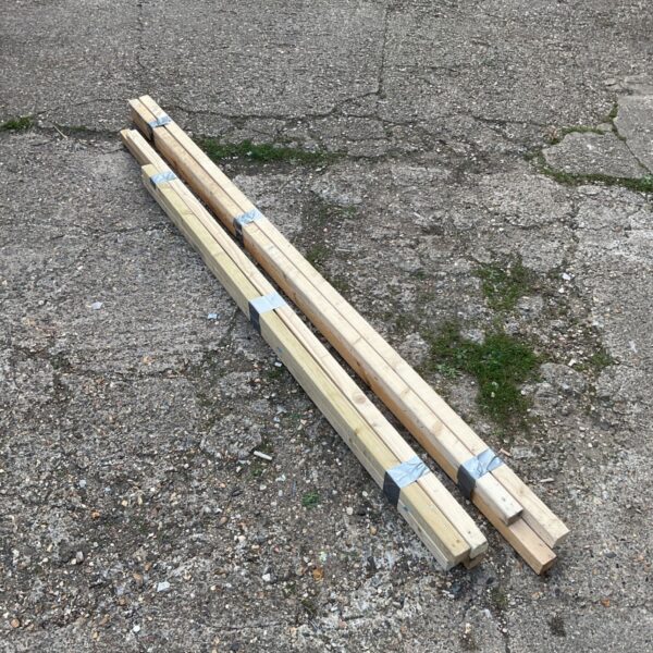 Bundles of reclaimed 2x2 wood lumber for DIY projects.