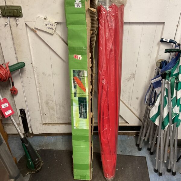 Red garden parasol still in its original packaging.