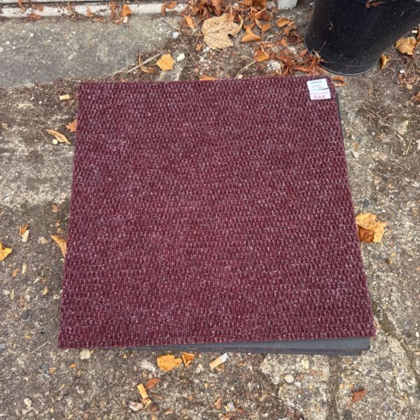Bundle of deep red office carpet tiles for flooring.