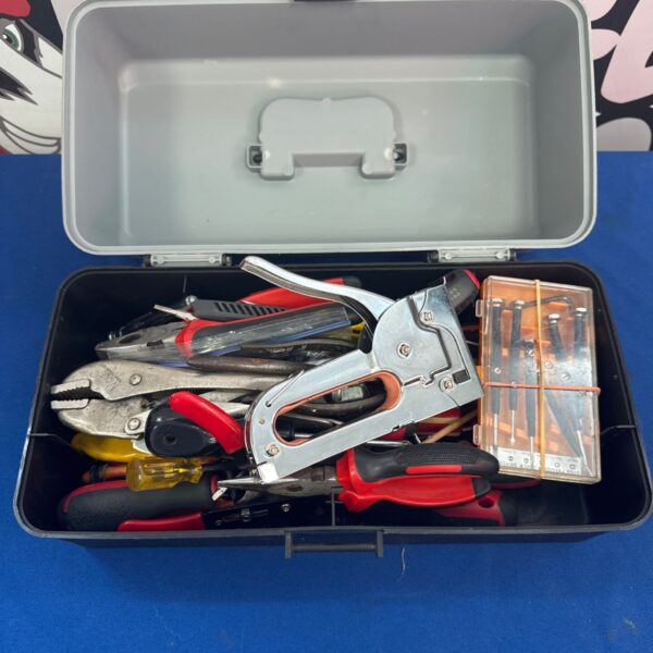 Red plastic toolbox filled with vintage hand tools for DIY repairs.