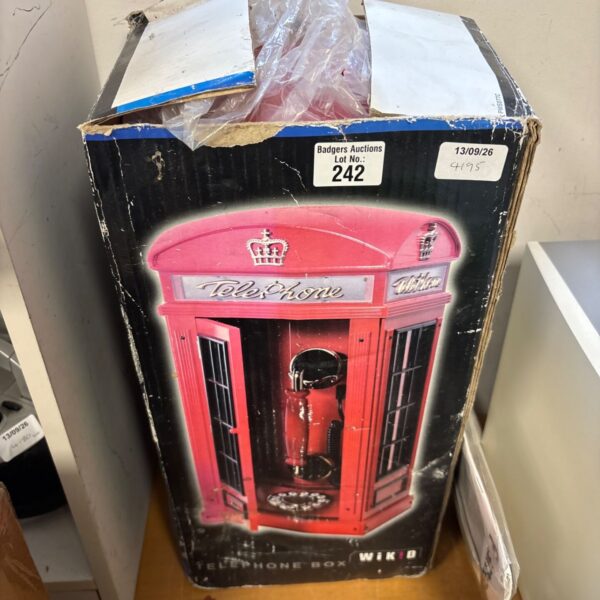 Red telephone shaped like a stack of books, vintage novelty item.