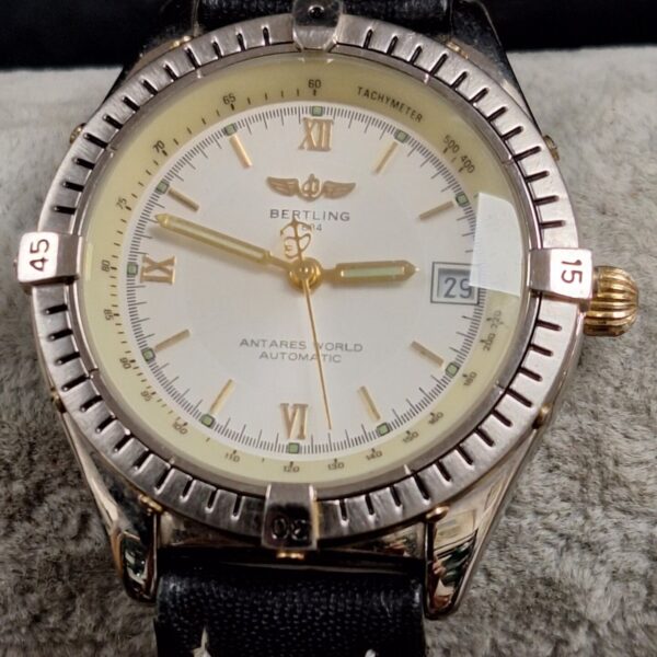 Replica Breitling wristwatch with gold case and black strap.